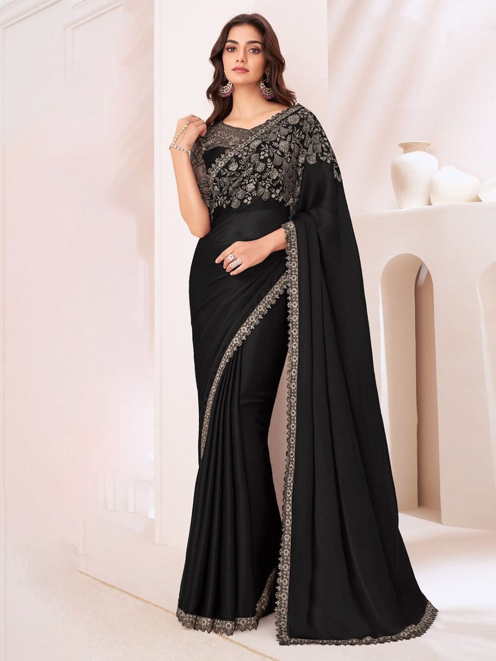 Product Details Design Details Black and grey saree Solid saree with embellished border border Has sequinned detail The saree comes with an unstitched blouse piece The blouse worn by the model might be for modelling purpose only. Check the image of the blouse piece to understand how the actual blouse piece looks like. Size & Fit Length: 5.5 metres plus 0.8 metre blouse piece Width: 1.06 metres (approx.) Material & Care Dry Clean