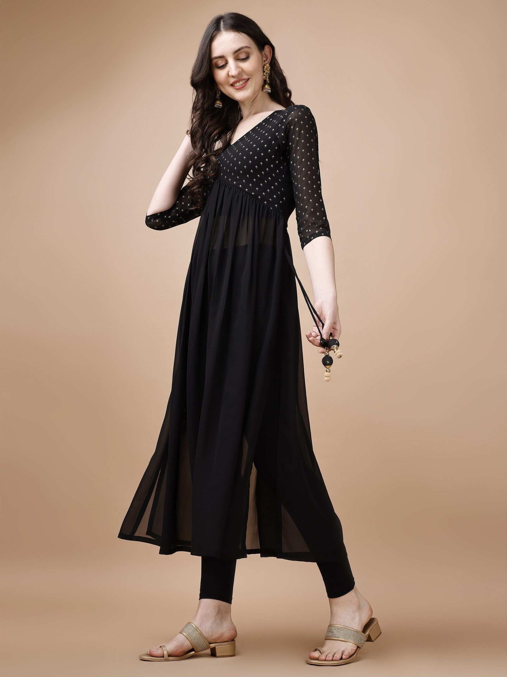 imgi_132_54RlYUkp_a65ff21fa39c496bb9647e240e865262 Product Details Colour: black Floral yoke design V-neck Three-quarter, regular sleeves A-line shape with pleated style Thread work detail Ankle length with flared hem Machine weave regular georgette Size & Fit The model (height 5'8) is wearing a size S Material & Care Georgette Dry Clean