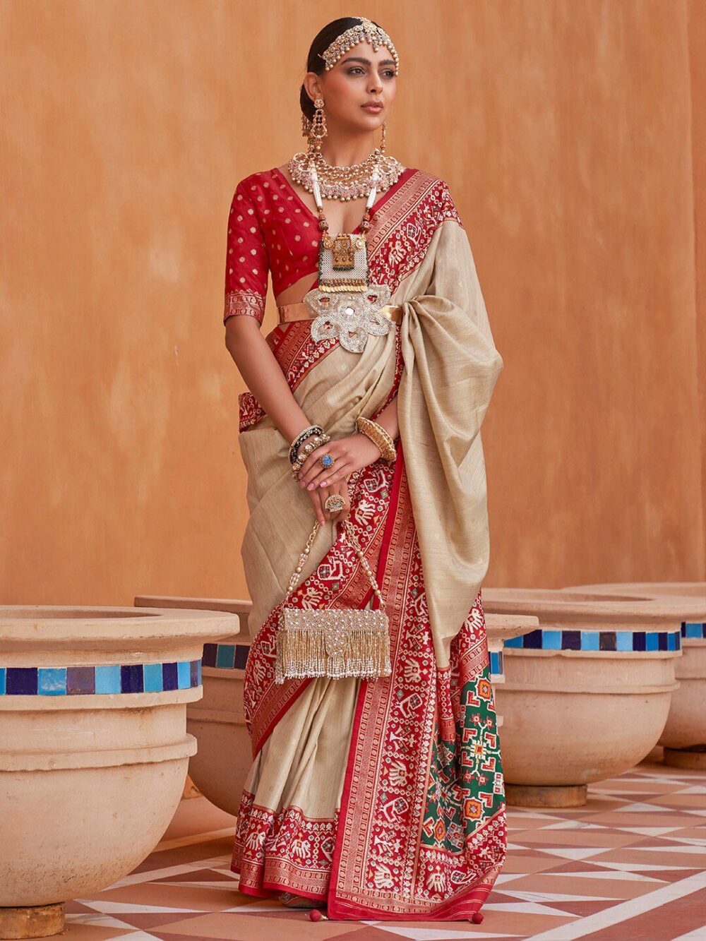 Discover the beauty of SEO limits with our cream-coloured & red woven design Zari silk blend Patola saree. Perfect for weddings, parties & festive occasions. Shop authentic Patola sarees online. ✨ Big Product Description (SEO Optimized + Long-Tail Keywords) Step into timeless elegance with our Cream-Coloured & Red Woven Design Zari Silk Blend Patola Saree – a masterpiece designed for women who cherish tradition with a modern twist. This Patola silk saree with zari weaving reflects the finest craftsmanship of Indian textiles, blending luxurious silk fabric with intricate handloom-inspired patterns. Perfect for weddings, parties, and festive celebrations, this designer silk blend saree with zari border complements every occasion. The cream-coloured base with rich red woven motifs enhances its royal appeal, while the zari work in gold and silver tones adds a touch of luxury. Whether you are looking for a traditional saree for Karva Chauth, a festive silk saree for Navratri Garba, or a Patola saree for Diwali, this elegant drape ensures you stand out. Its lightweight silk blend fabric makes it comfortable for long wear, while the woven zari details make it a versatile pick for bridal trousseau sarees, wedding reception outfits, and family functions. This saree is a must-have for women searching for: Patola silk saree with zari weaving online Affordable wedding saree in silk blend fabric Designer party wear saree with zari border Festive saree for Durga Puja, Karwa Chauth, and Diwali Traditional silk sarees for women with zari pallu Embrace the beauty of Indian ethnic wear with this cream and red zari silk blend saree, a perfect mix of grace, comfort, and grandeur. ✨ Product Highlights – Fabric: Silk Blend with Zari Weaving Colour: Cream base with Red woven design Design: Patola-inspired traditional motifs Border: Zari woven border with golden finish Occasion: Weddings, Parties, Festivals, Traditional Functions Style: Ethnic, Designer, Elegant 🔹 Variations & Uses – Can be styled with gold jewellery for weddings. Pair with lightweight oxidised jewellery for festive events. Suitable for bridesmaids, wedding guests, festive gatherings. Can be used as engagement saree, reception saree, Karva Chauth saree, or puja outfit. 🔹 Why Choose This Saree – Blend of comfort + luxury. Traditional Patola design with a modern touch. Budget-friendly designer look. Suitable for multi-occasion wear. High-quality zari weaving ensures durability. 🔹 Website & Ownership – This saree is brought to you with love & dedication by Renu Baliyan, Nity Baliyan, and Bharti Tomar, committed to delivering authentic & affordable ethnic wear collections online. 🔹 Push Offer Message – ✨ Hurry! Limited Stock Available – Shop the Cream & Red Zari Silk Patola Saree today and add royal elegance to your festive collection. Don’t miss out on this trending saree design – Order Now!