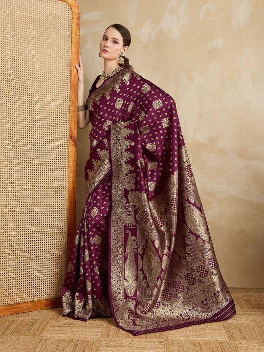 Product Details Design Details Maroon and gold-toned banarasi saree Woven design saree with woven design border border Has zari detail The saree comes with an unstitched blouse piece The blouse worn by the model might be for modelling purpose only. Check the image of the blouse piece to understand how the actual blouse piece looks like. Size & Fit Length: 5.5 metres plus 0.8 metre blouse piece Width: 1.06 metres (approx.) Material & Care Silk Blend Dry Clean