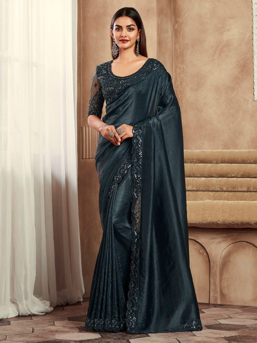 Embellished Sequinned Satin Saree, Sequin Satin Saree, Party Wear Satin Saree, Reception Wear Saree, Designer Saree Online, Bollywood Style Saree, Satin Saree with Sequins, Cocktail Saree, Festive Saree, Satin Saree Party Wear, Evening Saree, Glamorous Saree 2025, Satin Saree Online Shopping, Stylish Saree for Parties, Sequinned Saree India, Premium Satin Saree, Wedding Guest Saree, Saree for Reception Night, Luxury Satin Saree Online, Trending Saree Collection 2025 ✅ Big Product Description ✨ Add a touch of glamour to your wardrobe with our Embellished Sequinned Satin Saree, designed for women who love to sparkle at every occasion. Crafted from luxurious satin fabric, this saree drapes effortlessly while the delicate sequin embellishments give it a dazzling finish. The smooth, shiny satin texture paired with all-over sequins or highlighted borders makes it a show-stopping choice for cocktail parties, receptions, festive celebrations, weddings, and evening events. Whether you want a bold Bollywood-inspired look or an elegant party vibe, this saree is sure to make heads turn. 🌸 Key Highlights ✔️ Fabric: Premium Satin – soft, glossy & smooth ✔️ Work: Hand-embellished sequins with fine detailing ✔️ Style: Modern glamour with a chic drape ✔️ Occasions: Party wear, reception saree, cocktail nights, festive gatherings ✔️ Care: Dry clean recommended to preserve shine & sequin work 🌟 Why Choose This Saree? Perfect for night parties, receptions & fashion events Lightweight satin fabric with glamorous sequin shine A modern Bollywood-style saree for stylish women Easy to pair with statement jewelry & high heels A trending 2025 saree collection must-have 🔑 SEO Keyword Expansion (Keyword Rich Integration) This Embellished Sequinned Satin Saree is ideal for women looking for party wear sarees, sequin sarees online, designer satin sarees, Bollywood-style party sarees, luxury satin sarees, cocktail wear sarees, evening wear sarees, festive sarees 2025, satin sarees with sequin borders, premium reception sarees, and glamorous wedding guest sarees. From cocktail parties, evening receptions, Diwali parties, engagement nights, New Year events, and anniversary celebrations, this saree ensures you shine wherever you go. ✅ Website Ownership (Professional Mention) This saree is featured on our platform, proudly owned and managed by Renu Baliyan, Nity Baliyan, and Bharti Tomar.