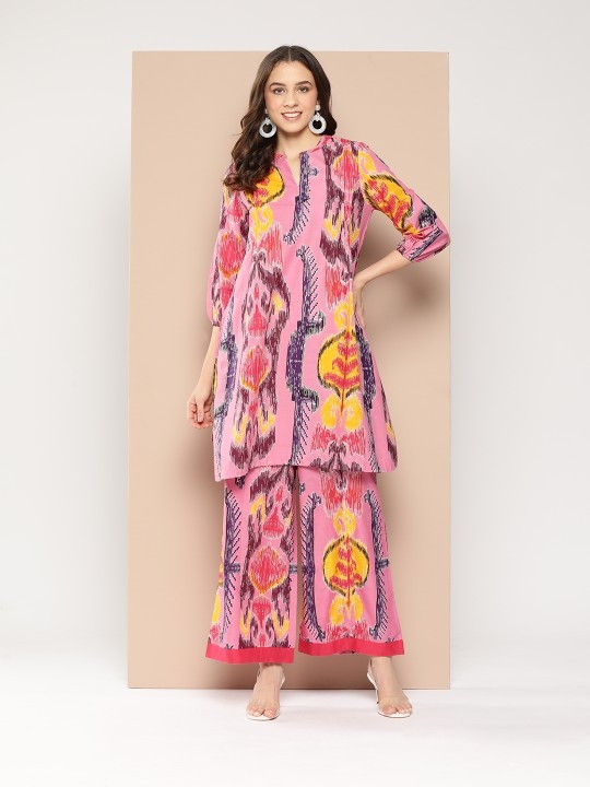 fancy kurti -my Product Details Pink printed Kurta with Palazzos Kurta design: Abstract printed Straight shape Regular style Mandarin collar, three-quarter puffed sleeves Knee length length with straight hem Pure cotton machine weave fabric Palazzos design: Printed Palazzos Partially elasticated waistband Slip-on closure Size & Fit Size worn by the model: S Chest: 31'' Waist: 29.5'' Hips: 39'' Height: 5'6" Material & Care Top fabric: Pure Cotton Bottom fabric: Pure Cotton Hand wash